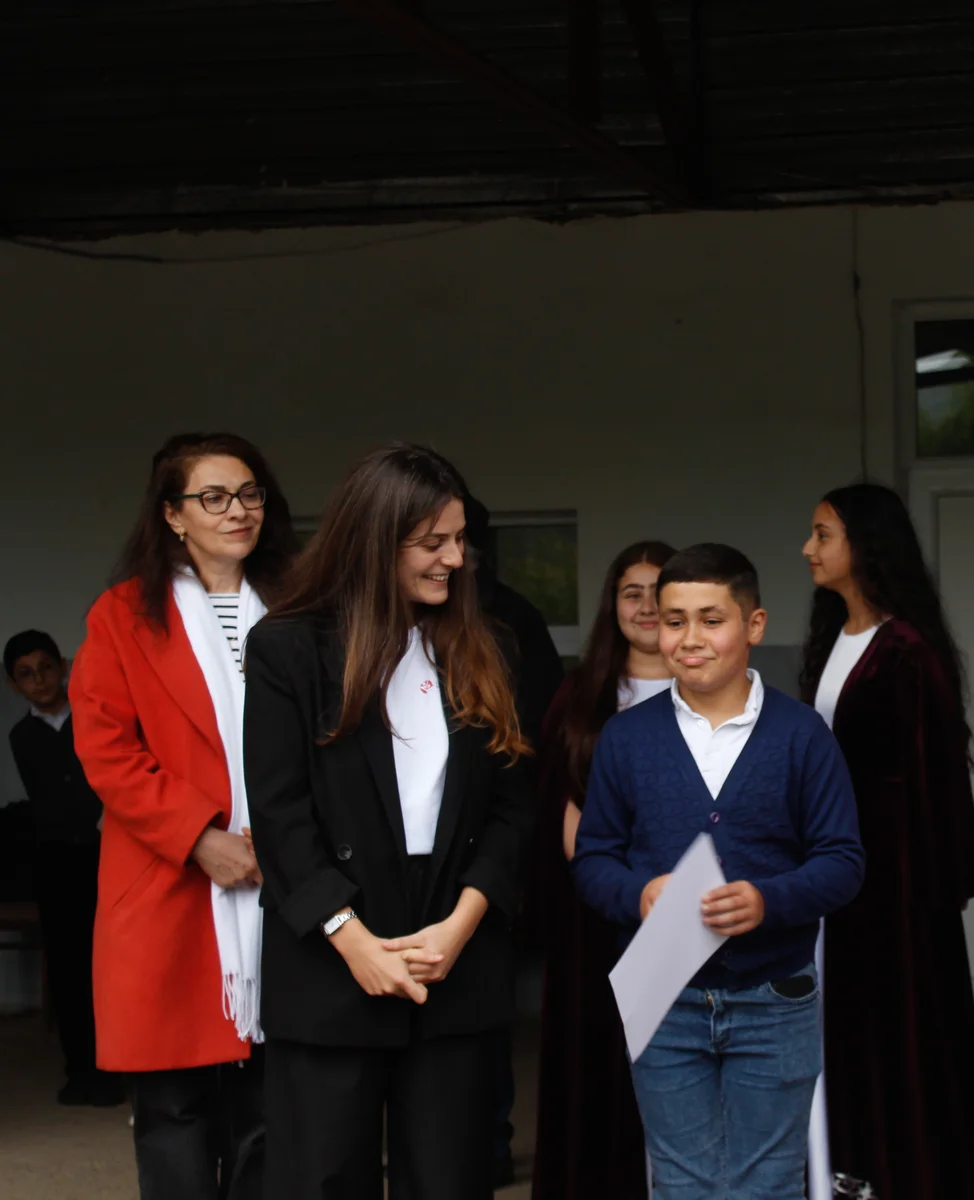A student receives a certificate at the Hydrogreen Tavush contest ceremony