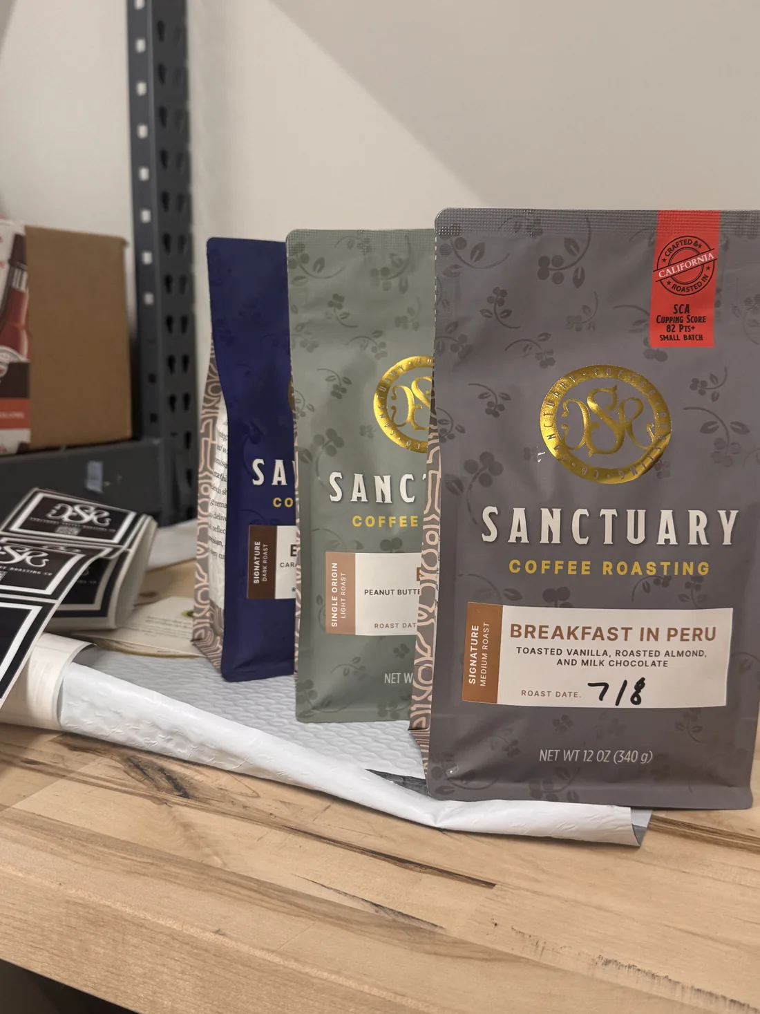 Bags of Sanctuary Coffee Roasting coffee, including Breakfast in Peru, hand dated with the roast date
