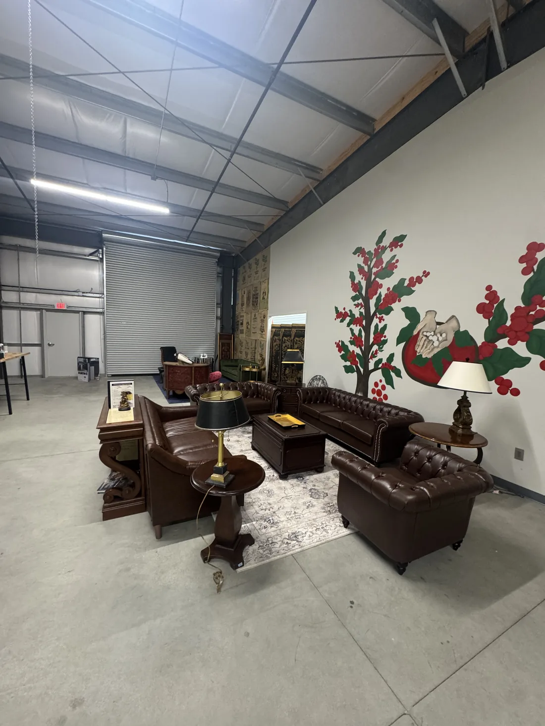 The lounge at Sanctuary Coffee Roasting Company in Clovis, with leather chesterfield sofas and a hand painted coffee cherry mural